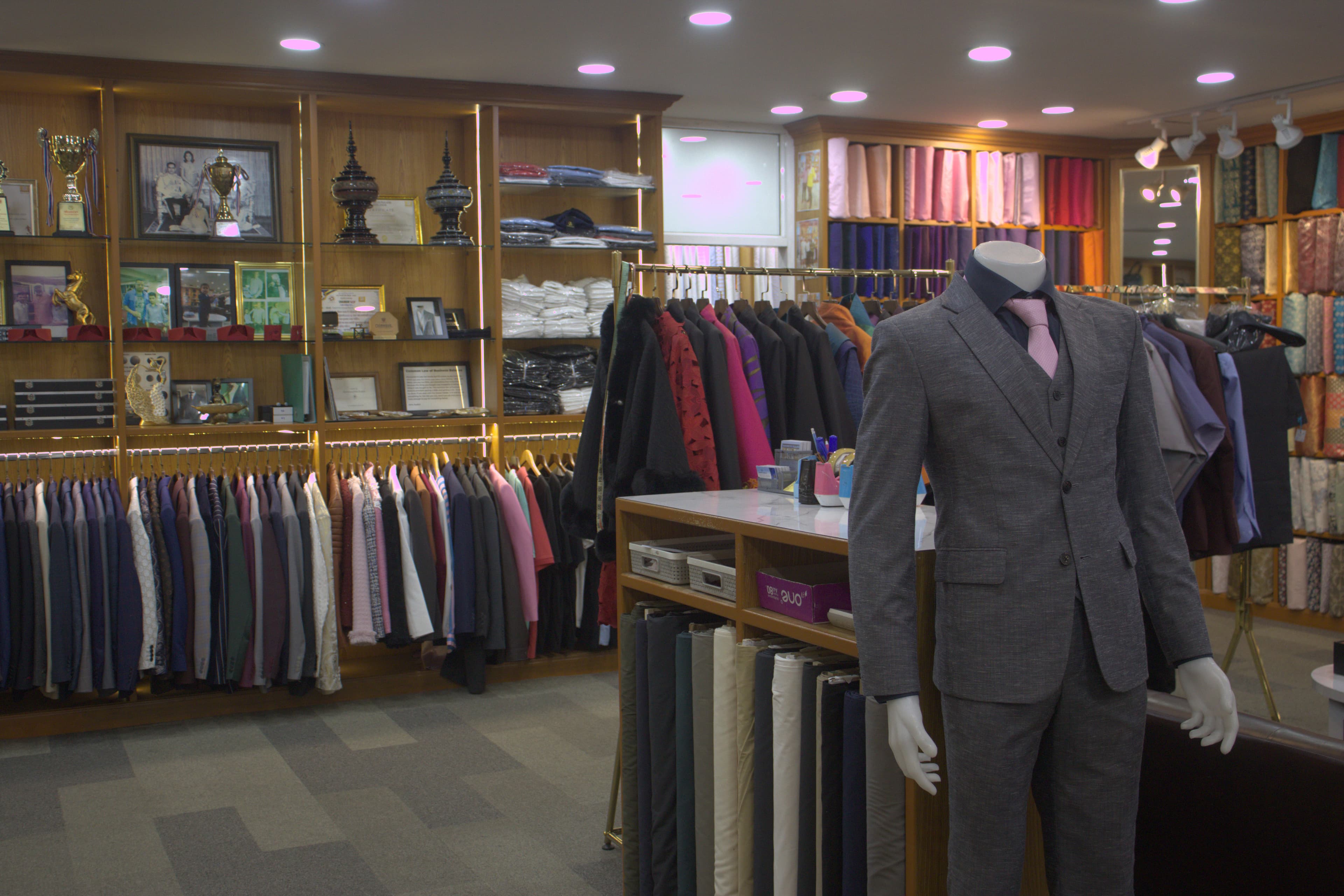 A calm boutique interior with tailored clothes on rails